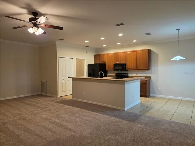 a view of kitchen with kitchen island sink stainless steel appliances and cabinets