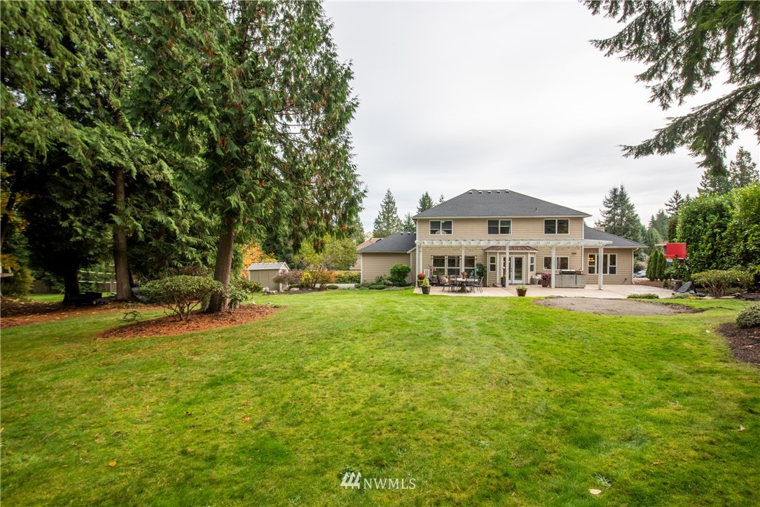 21008 47th Drive Southeast Bothell, WA 98021 - Photo 22 of 25 a view of a house with a big yard and large trees