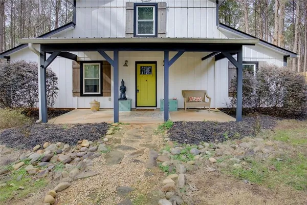 a front view of a house with garden