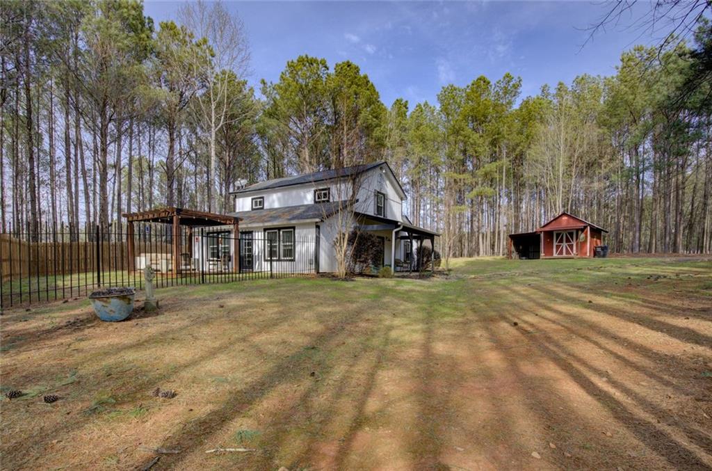 2100 Morgan Lane Covington, GA 30014 - Photo 12 of 47 a view of a big house with a big yard and large trees