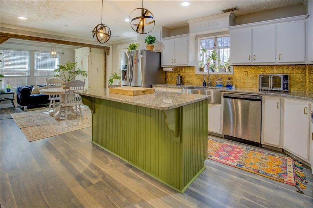 2100 Morgan Lane Covington, GA 30014 - Photo 26 of 47 a kitchen with cabinets and wooden floor