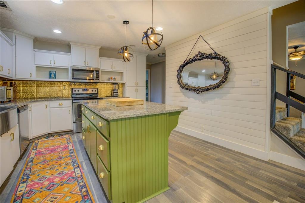 2100 Morgan Lane Covington, GA 30014 - Photo 28 of 47 a kitchen with cabinets and wooden floor