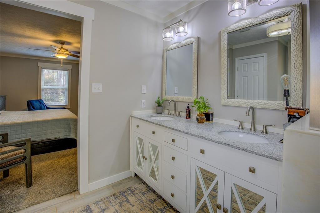 2100 Morgan Lane Covington, GA 30014 - Photo 32 of 47 a en suite bathroom with double sink and a mirror