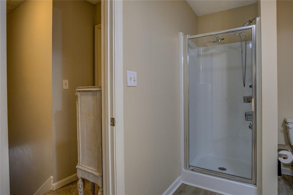 2100 Morgan Lane Covington, GA 30014 - Photo 35 of 47 a bathroom with a glass shower door