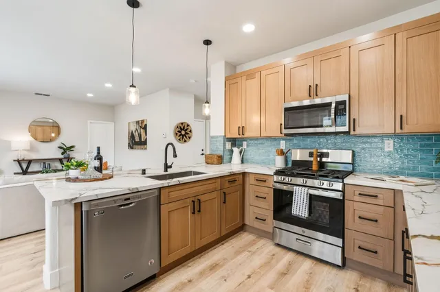 a kitchen with a sink stove and microwave