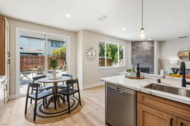 a kitchen with a sink a stove and chairs