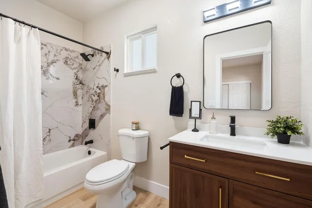 a bathroom with a sink a toilet and a bathtub