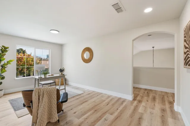 a view of a livingroom with furniture window and wooden floor