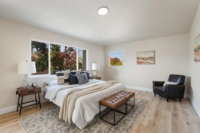 a bedroom with a bed and a large window