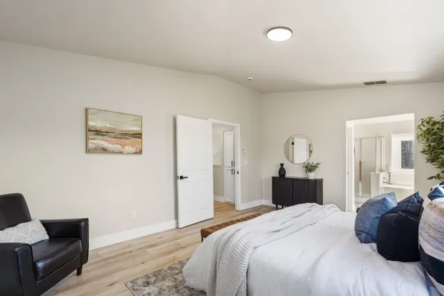 a bedroom with bed and chair