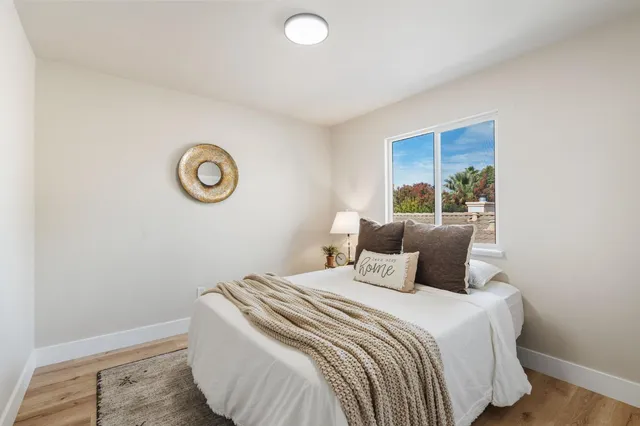 a bedroom with a bed and a window