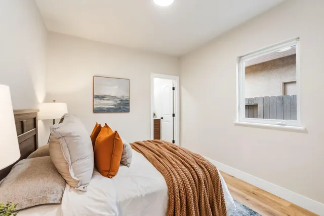 a bedroom with a bed and a mirror