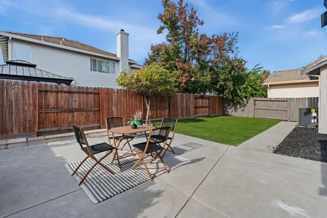 a view of backyard with outdoor seating a patio and plants