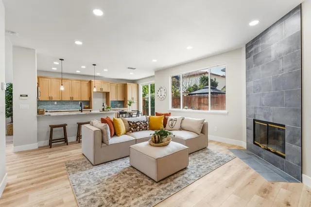 a living room with furniture and a fireplace