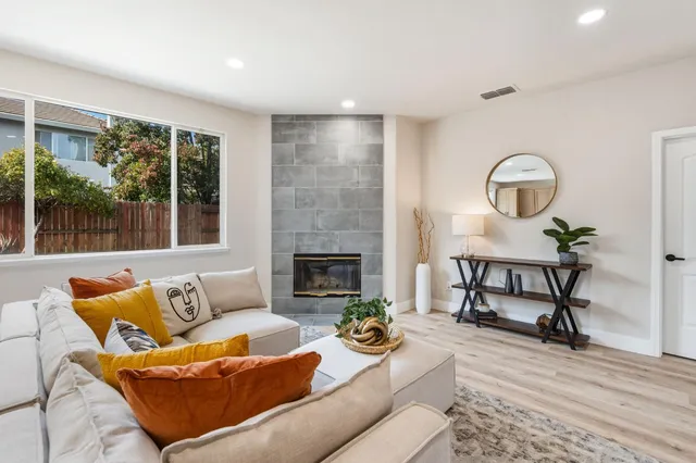 a living room with furniture and a fireplace