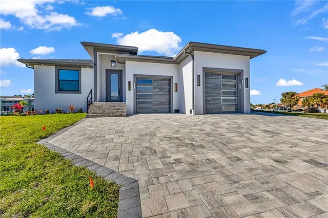 a view of a house with a yard and garage