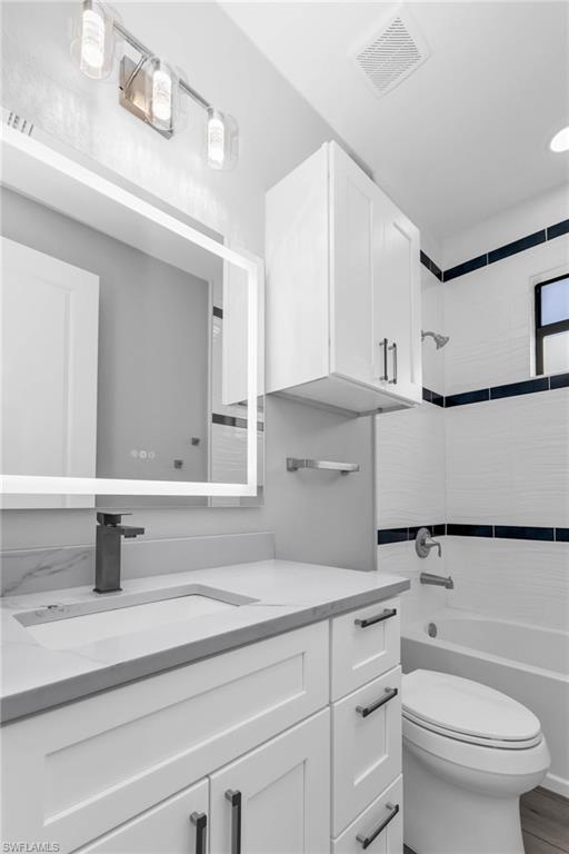 1323 Wesley Drive Punta Gorda, FL 33950 - Photo 21 of 50 a bathroom with a sink a toilet and mirror