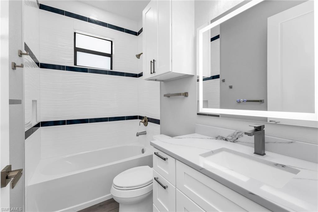 1323 Wesley Drive Punta Gorda, FL 33950 - Photo 22 of 50 a bathroom with a granite countertop sink toilet and shower