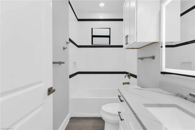 a bathroom with a toilet sink and shower