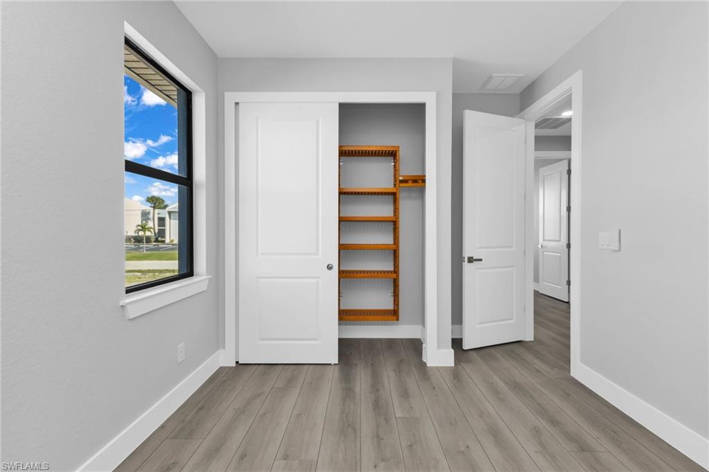 1323 Wesley Drive Punta Gorda, FL 33950 - Photo 27 of 50 an empty room with closet and windows