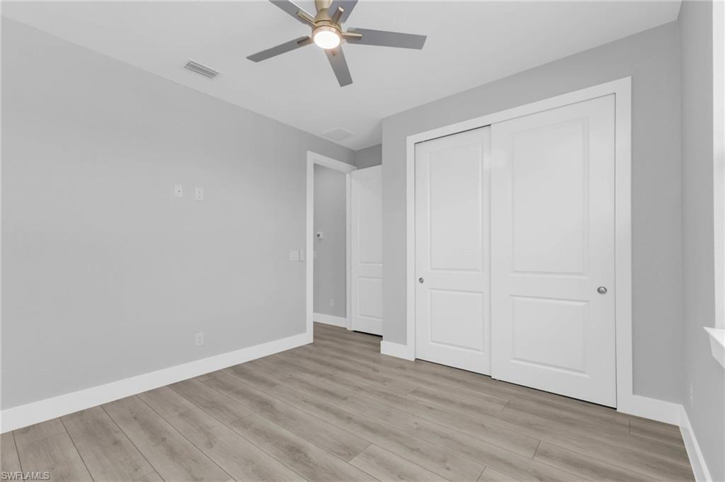 1323 Wesley Drive Punta Gorda, FL 33950 - Photo 28 of 50 a view of an empty room with wooden floor