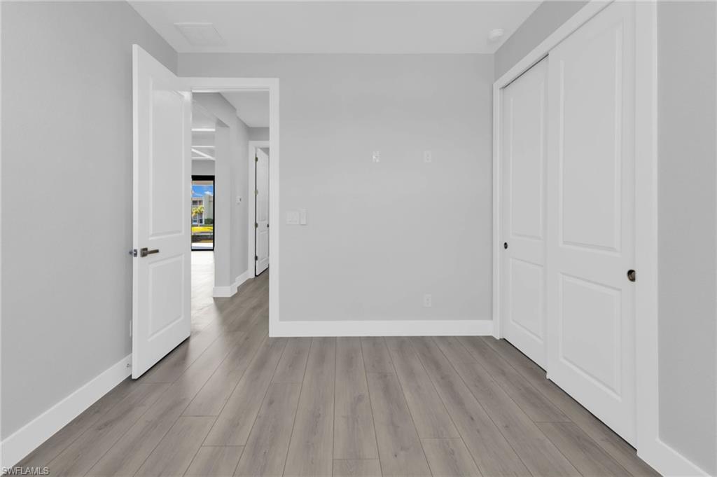 1323 Wesley Drive Punta Gorda, FL 33950 - Photo 29 of 50 a view of a hallway with wooden floor