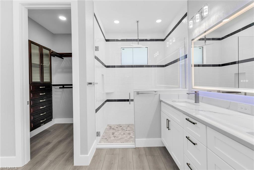 1323 Wesley Drive Punta Gorda, FL 33950 - Photo 33 of 50 a bathroom with a sink a mirror and a shower