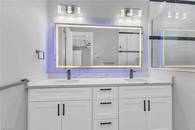 a bathroom with a sink and a mirror