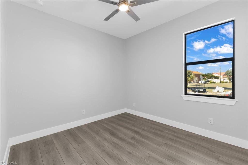 1323 Wesley Drive Punta Gorda, FL 33950 - Photo 41 of 50 a view of empty room with wooden floor and fan