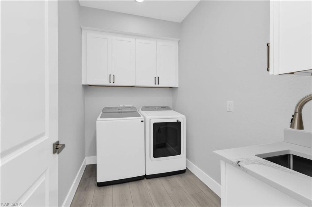 1323 Wesley Drive Punta Gorda, FL 33950 - Photo 42 of 50 a utility room with sink dryer and washer