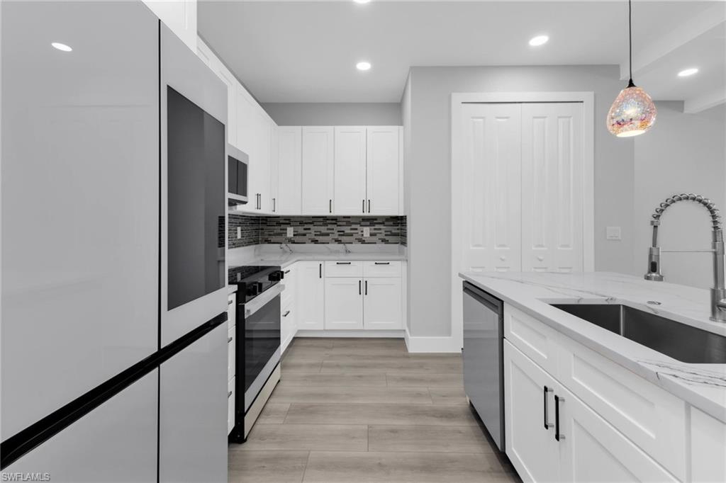 1323 Wesley Drive Punta Gorda, FL 33950 - Photo 7 of 50 a kitchen with granite countertop a sink stainless steel appliances and cabinets