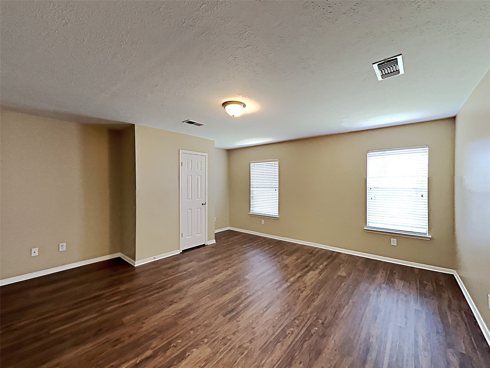 7203 Glen Rosa Drive Katy, TX 77494 - Photo 12 of 22 an empty room with wooden floor and windows
