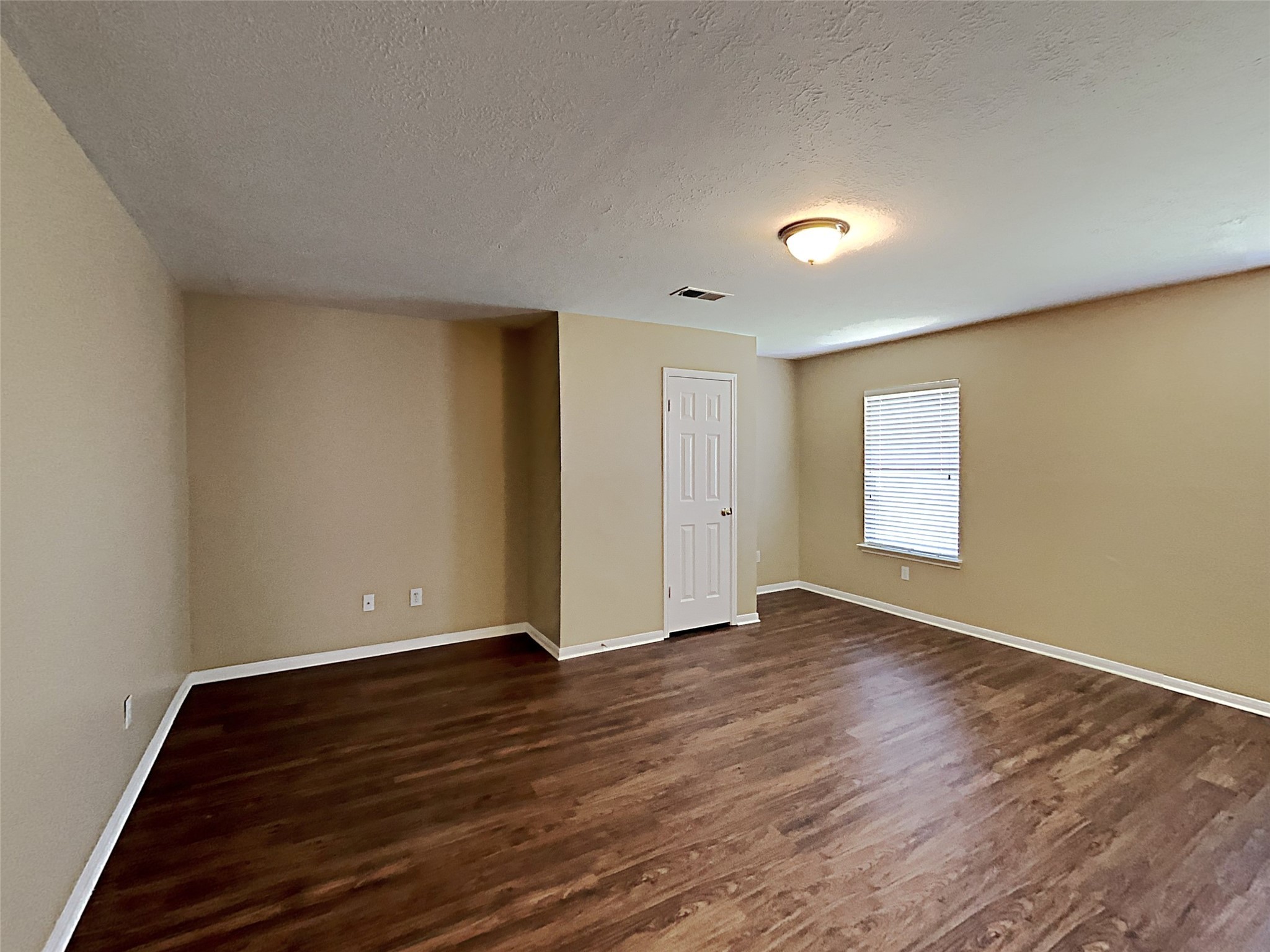 7203 Glen Rosa Drive Katy, TX 77494 - Photo 13 of 22 an empty room with wooden floor and windows