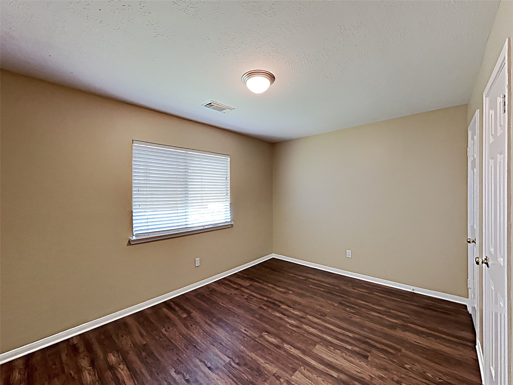 7203 Glen Rosa Drive Katy, TX 77494 - Photo 16 of 22 a view of an empty room with wooden floor and a window