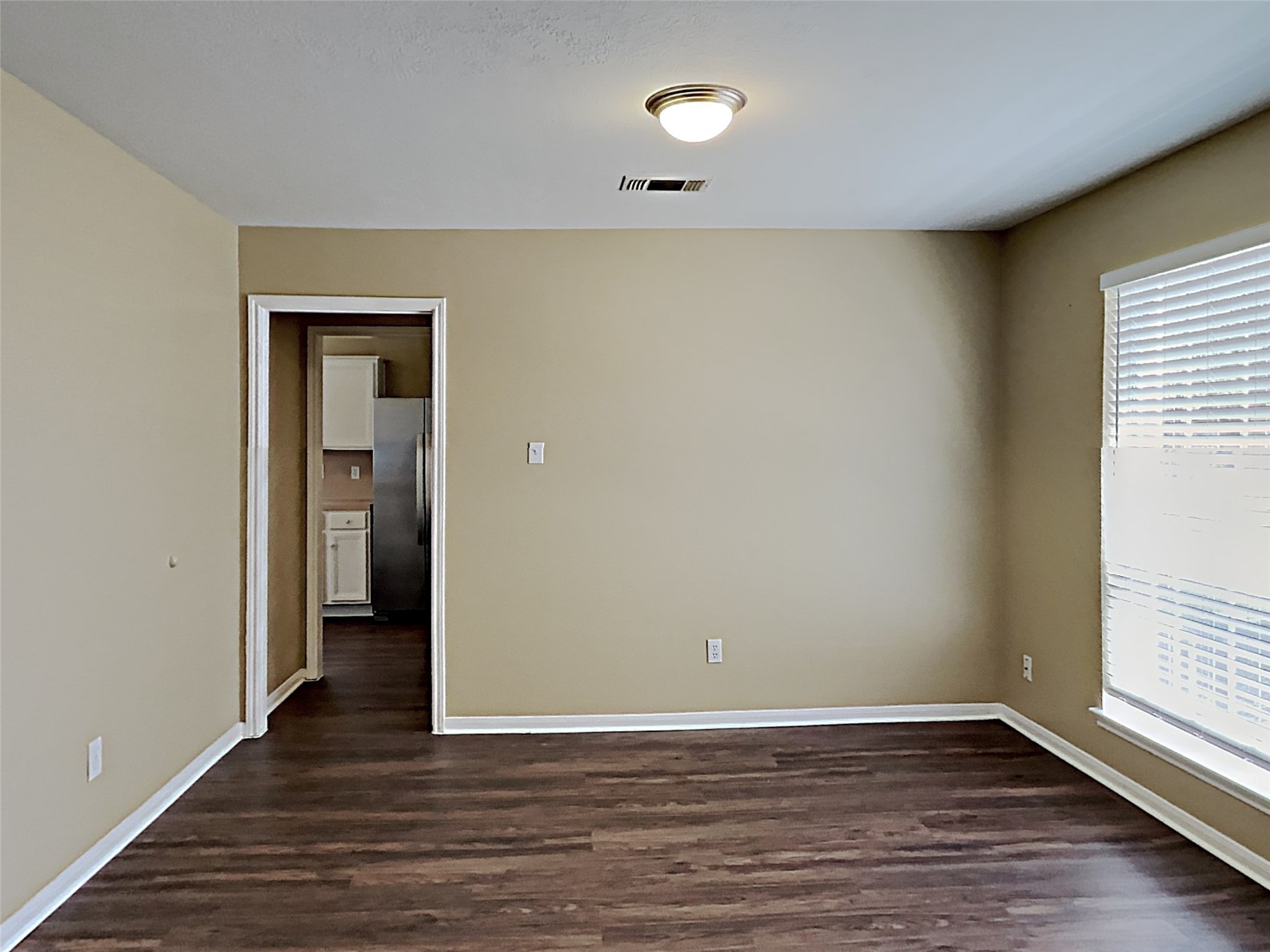 7203 Glen Rosa Drive Katy, TX 77494 - Photo 5 of 22 a view of an empty room with wooden floor and a window