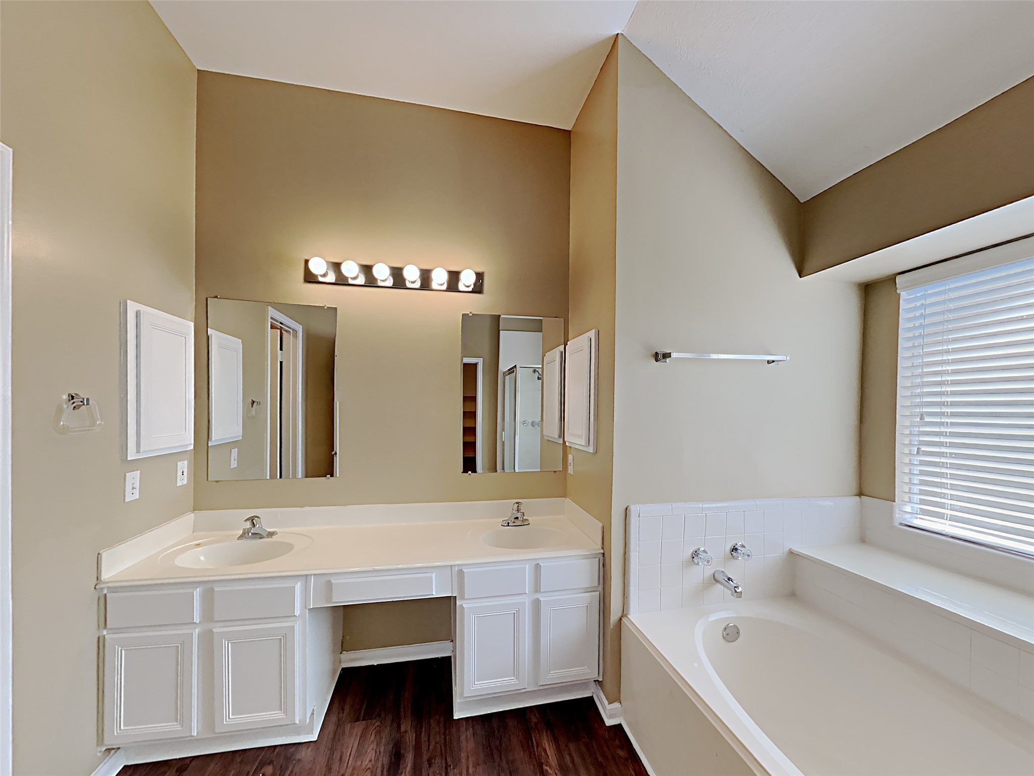 7203 Glen Rosa Drive Katy, TX 77494 - Photo 10 of 22 a bathroom with a bathtub a double vanity sink and a large mirror