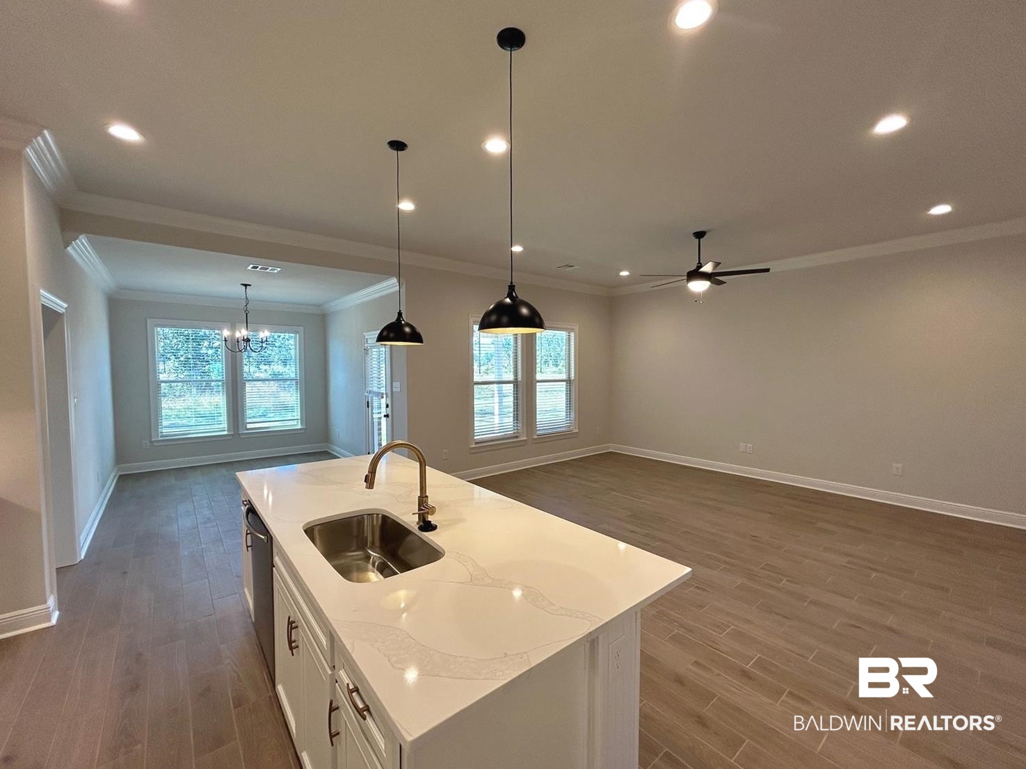 872 Sumter Loop Foley, AL 36535 - Photo 4 of 18 Kitchen featuring a center island with sink, sink, white cabinetry, and wood-type flooring