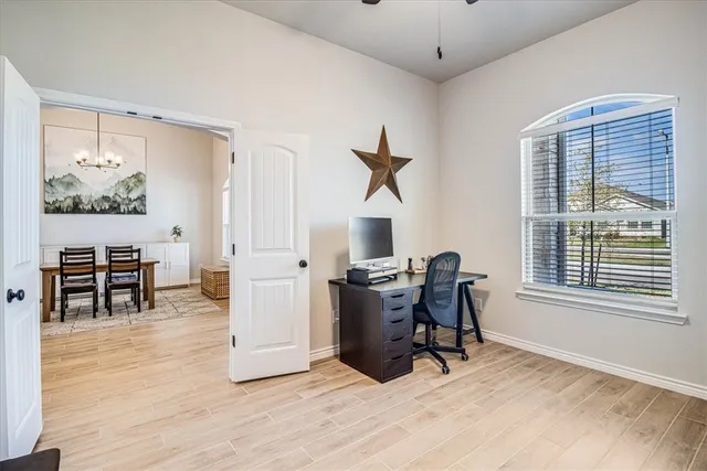 a workspace with furniture window and wooden floor