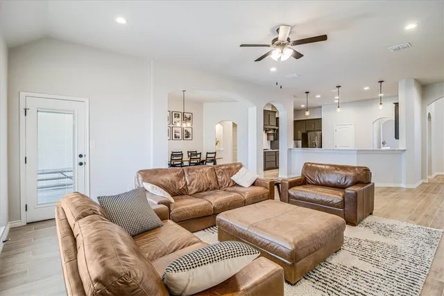 a living room with furniture and kitchen view