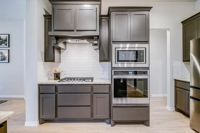 a kitchen with a stove and a microwave