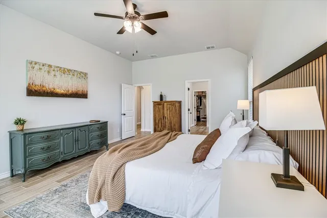 a bedroom with a bed and a dresser