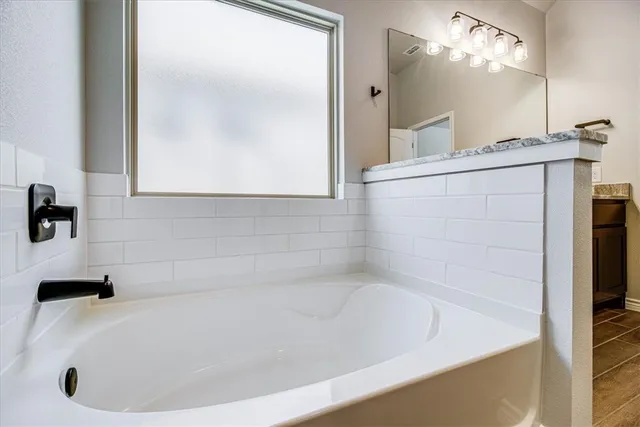 a white bath tub sitting in a bathroom