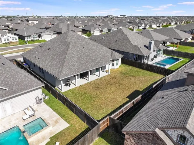an aerial view of residential houses with an outdoor space