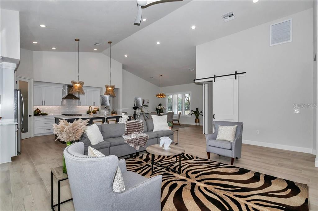 1631 West Highway 329 Citra, FL 32113 - Photo 21 of 82 a living room with lots of furniture and a chandelier