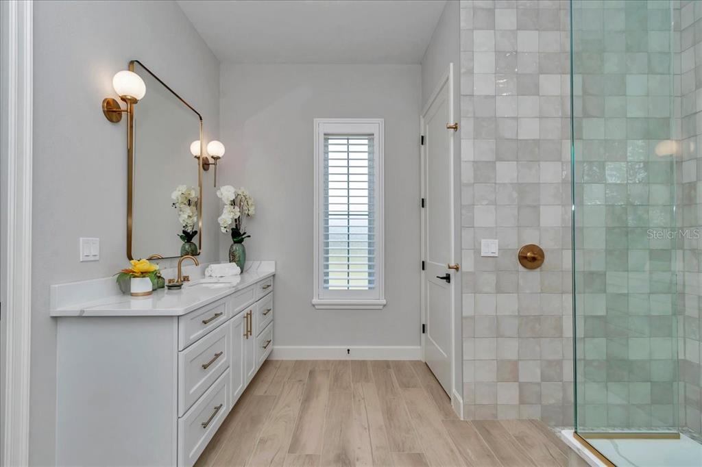 1631 West Highway 329 Citra, FL 32113 - Photo 33 of 82 a bathroom with a granite countertop sink a mirror and a shower