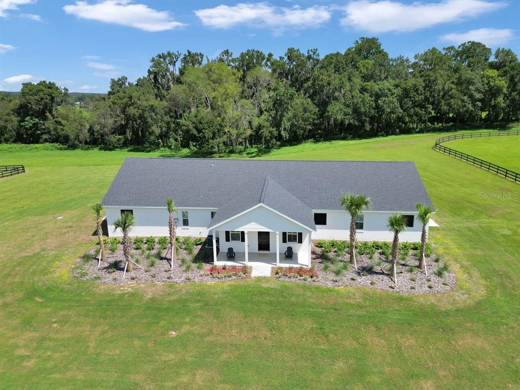 1631 West Highway 329 Citra, FL 32113 - Photo 50 of 82 a aerial view of a house with a yard table and chairs