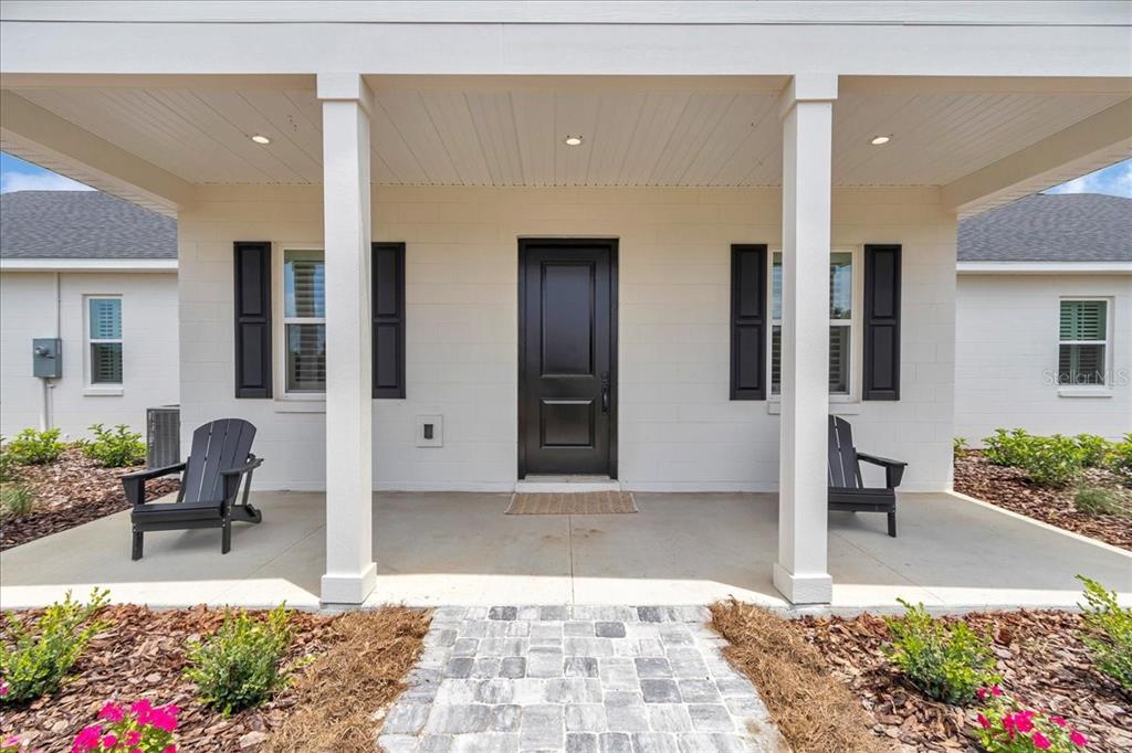 1631 West Highway 329 Citra, FL 32113 - Photo 55 of 82 a view of a patio with table and chairs potted plants