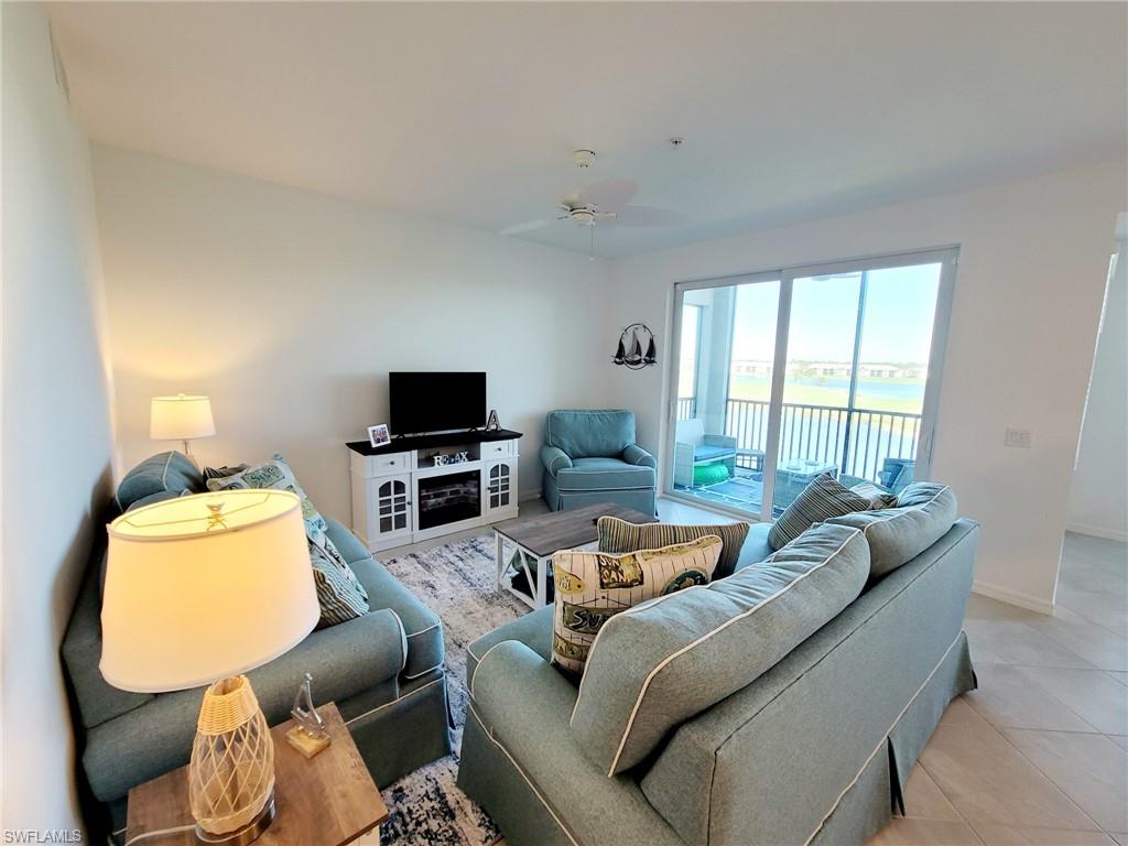 43997 Boardwalk Loop, Unit 1832 Babcock Ranch, FL 33982 - Photo 2 of 22 a living room with furniture and a flat screen tv