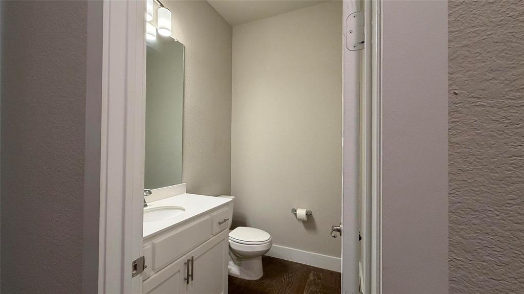 912 Fallbrook Avenue Denton, TX 76210 - Photo 15 of 26 a bathroom with a granite countertop toilet and a sink