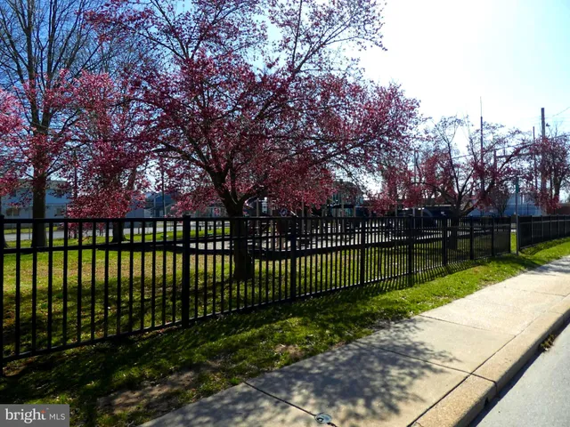 a view of a yard with wooden fence